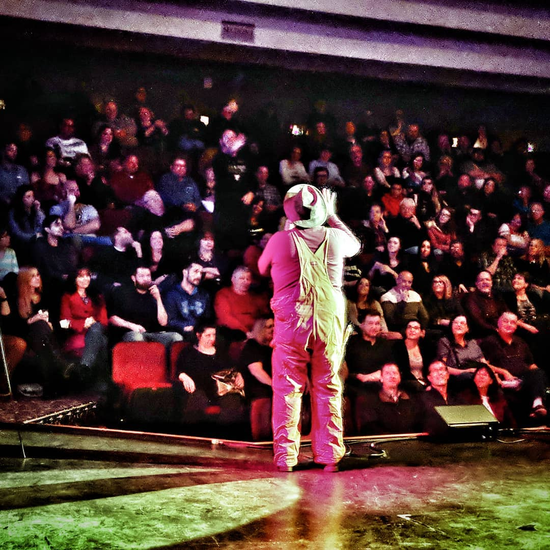 A glimpse from the stage—Matt Donnelly addresses a packed theater, showcasing the energy and excitement of live entertainment.