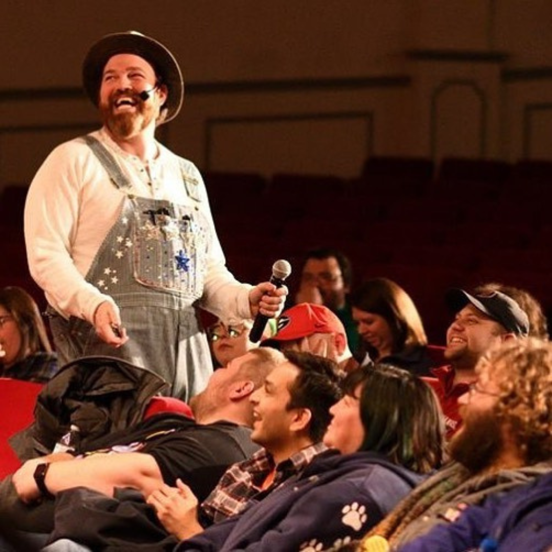 Dressed in overalls and a wide-brim hat, Matt Donnelly engages the audience with humor and charm, creating a truly immersive experience.